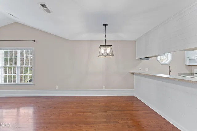 a view of a kitchen with a sink cabinets and wooden floor