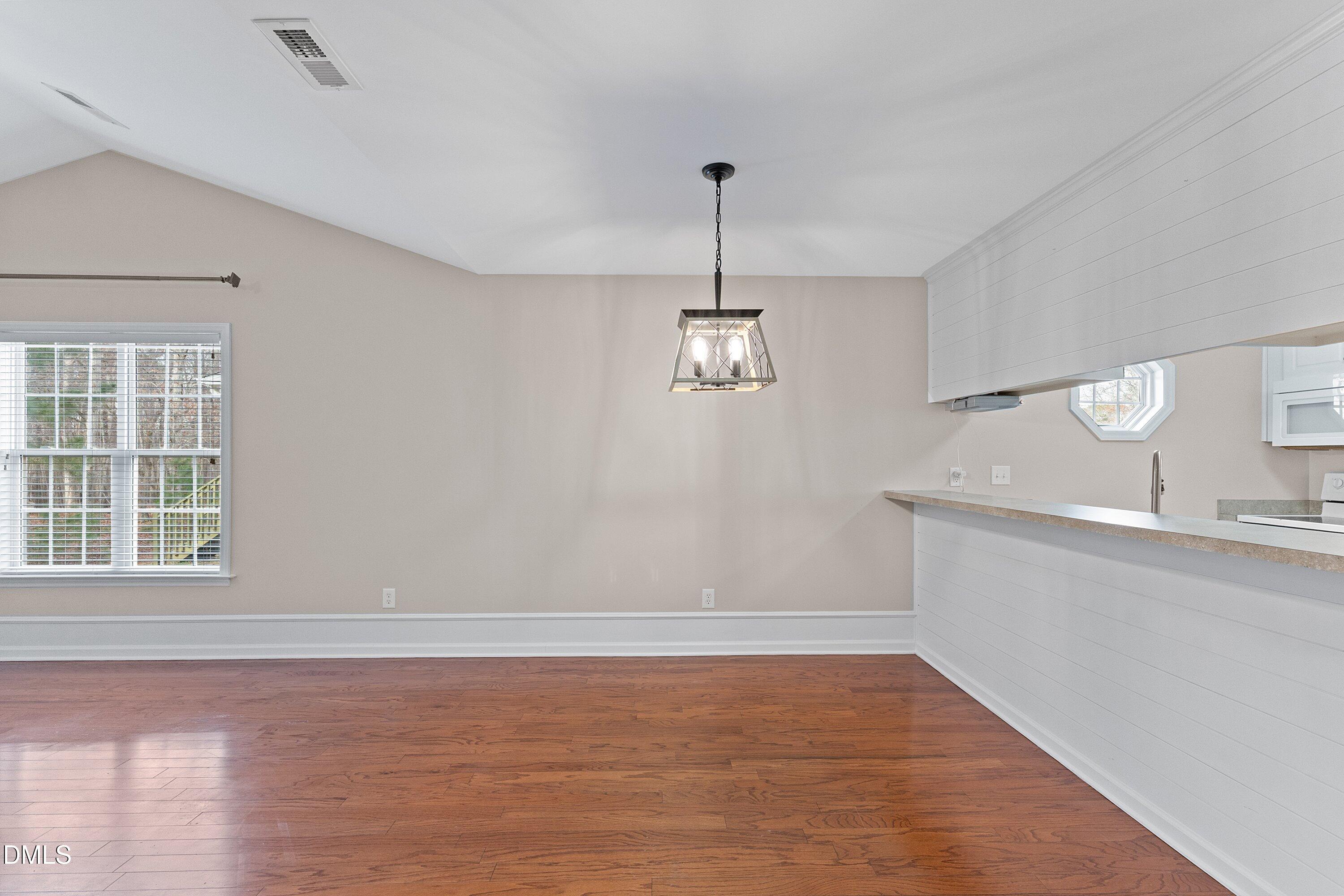 3666 East Cotton Gin Drive Clayton, NC 27527 - Photo 11 of 33 a view of a kitchen with a sink cabinets and wooden floor