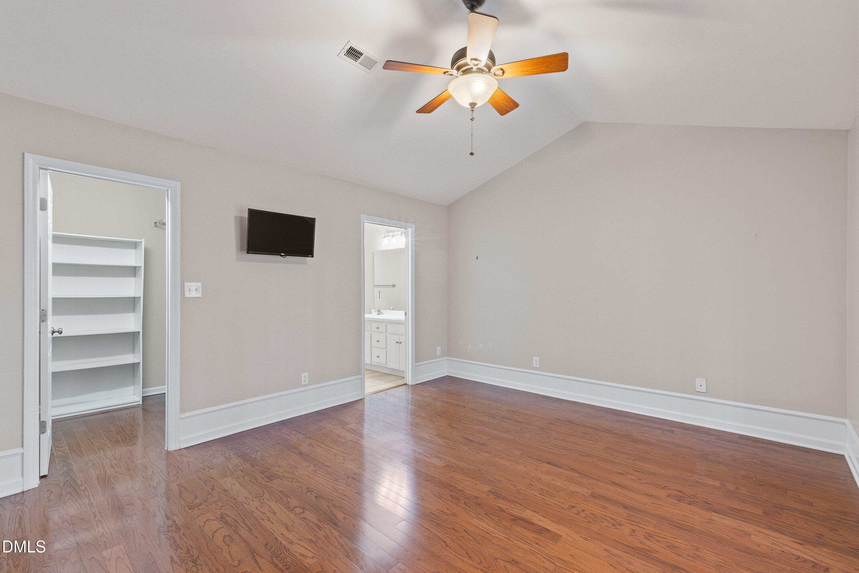 3666 East Cotton Gin Drive Clayton, NC 27527 - Photo 19 of 33 a view of an empty room with a window and wooden floor