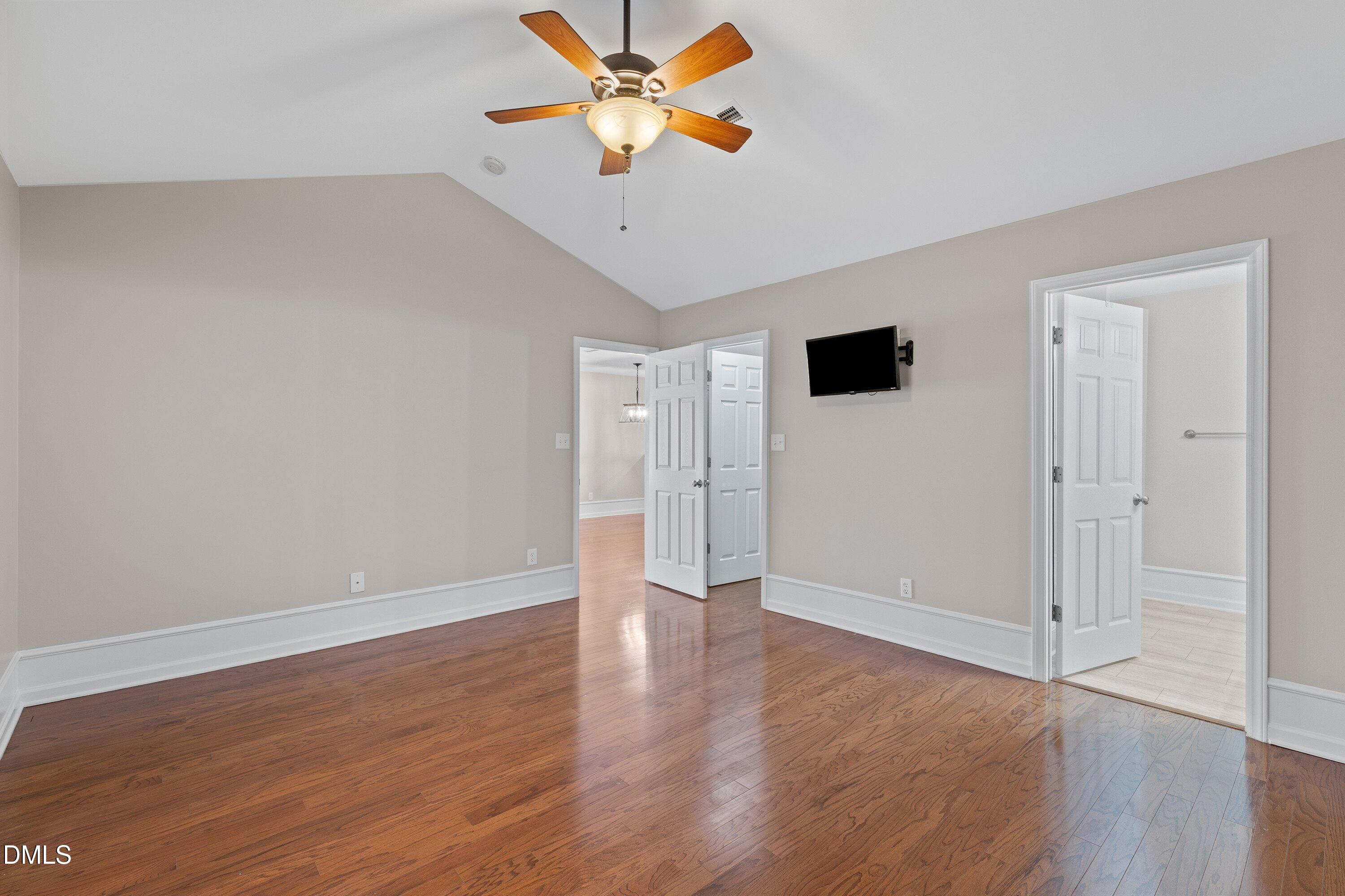 3666 East Cotton Gin Drive Clayton, NC 27527 - Photo 20 of 33 a view of an empty room with wooden floor