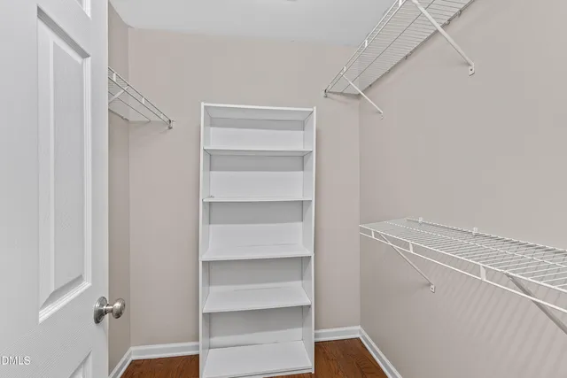 a view of walk in closet with empty racks