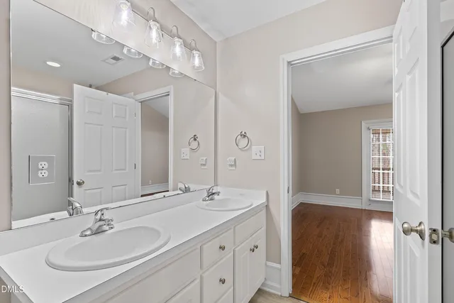 a bathroom with a sink double vanity and a mirror
