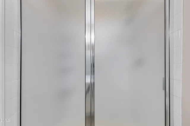 an empty room with wooden floor chandelier fan and windows