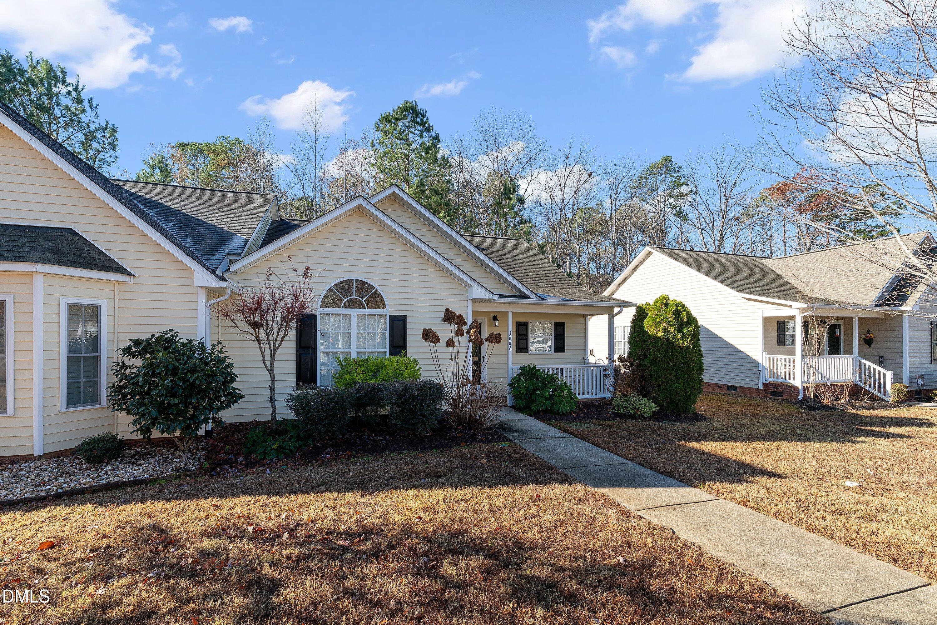 3666 East Cotton Gin Drive Clayton, NC 27527 - Photo 4 of 33 a front view of a house with garden