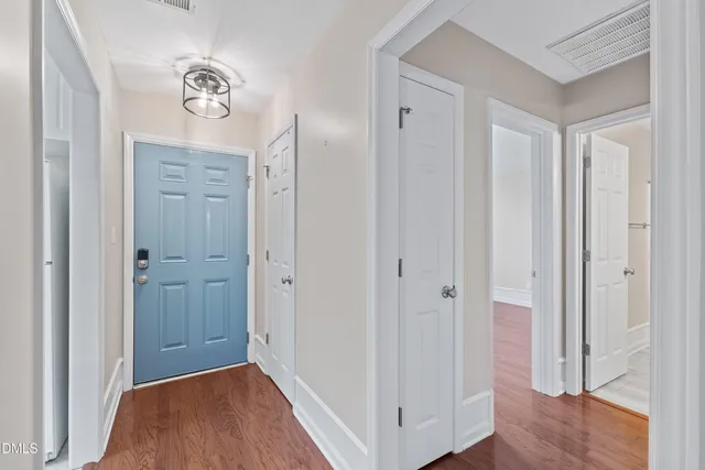 a view of a hallway with wooden floor