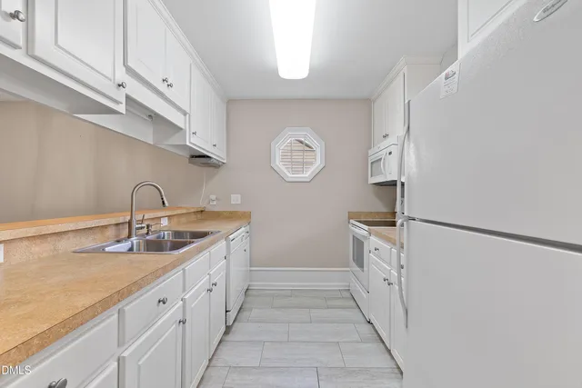 a spacious bathroom with a sink and a mirror