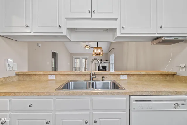 a kitchen with white cabinets and a sink
