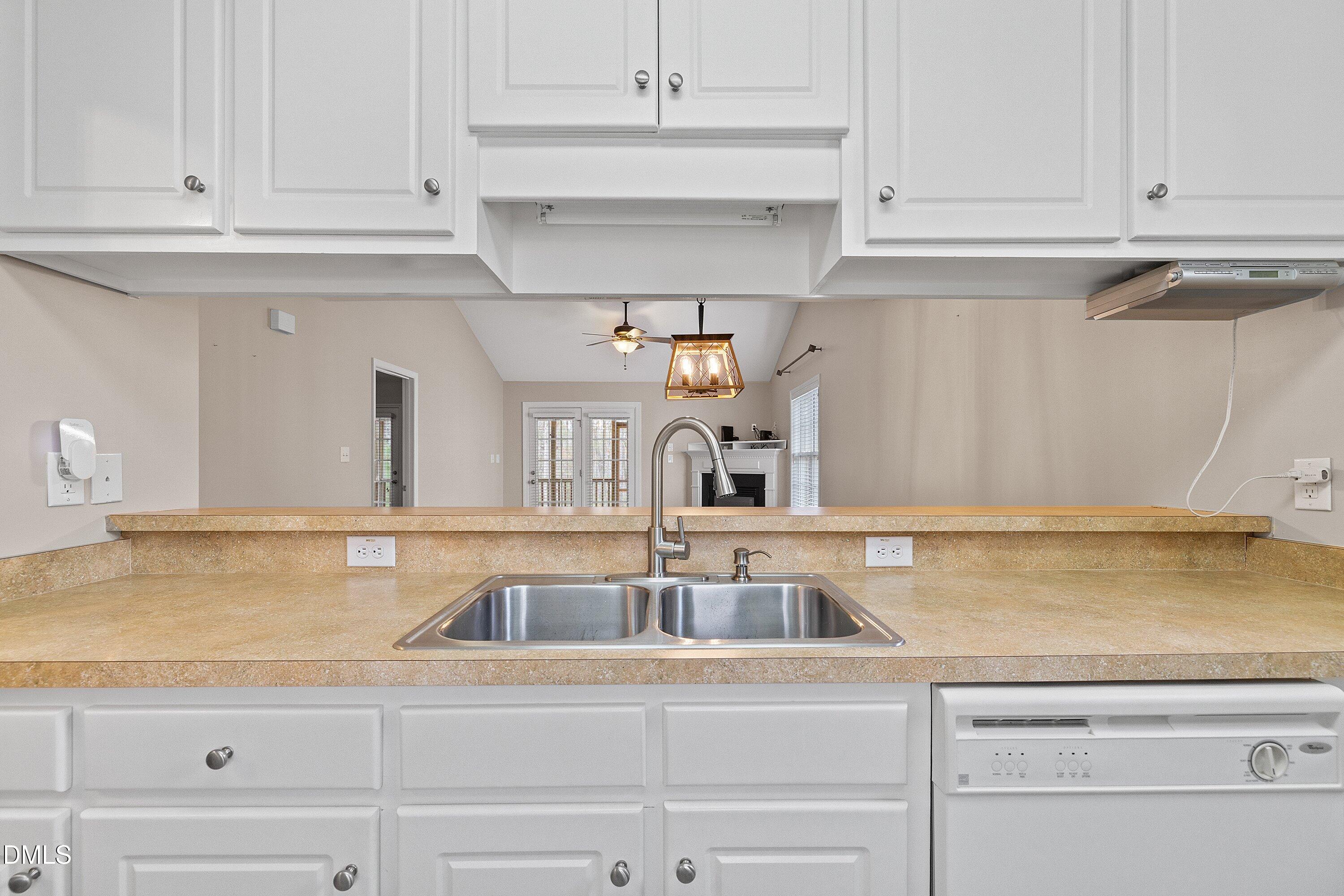 3666 East Cotton Gin Drive Clayton, NC 27527 - Photo 8 of 33 a kitchen with white cabinets and a sink