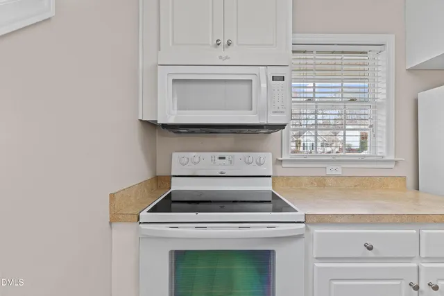 a stove top oven sitting inside of a kitchen