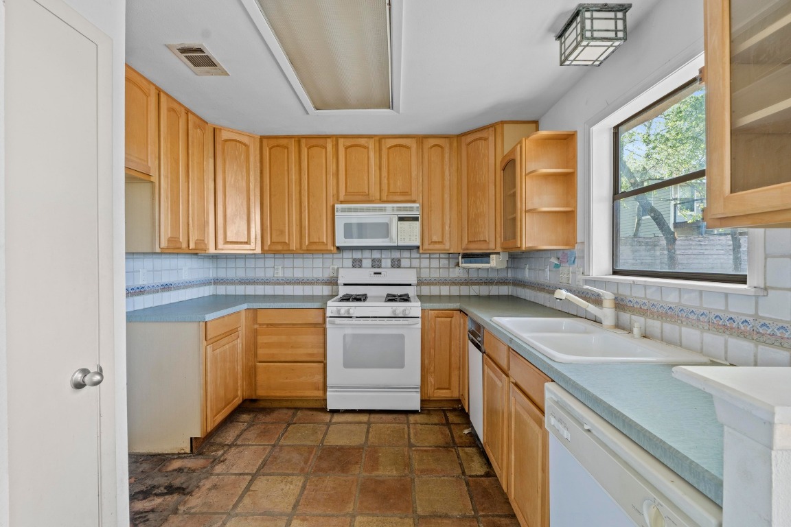 1811 Palma Plaza Austin, TX 78703 - Photo 11 of 17 a kitchen with a sink stove and cabinets