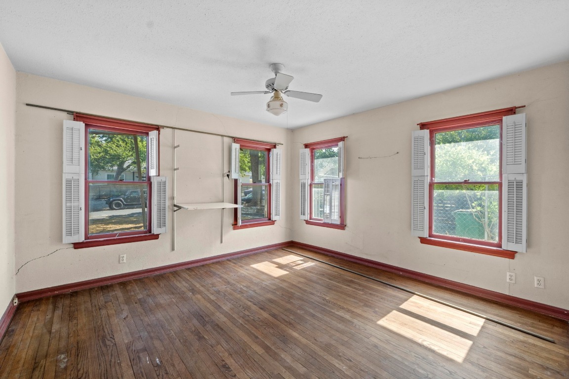 1811 Palma Plaza Austin, TX 78703 - Photo 12 of 17 a view of an empty room with wooden floor and a window