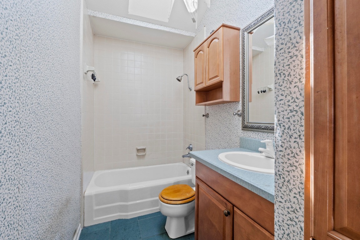 1811 Palma Plaza Austin, TX 78703 - Photo 13 of 17 a bathroom with a granite countertop toilet a sink and a bathtub