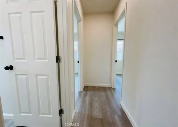 a view of a hallway with wooden floor