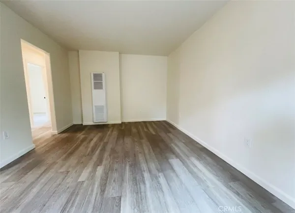 a view of a room with wooden floor