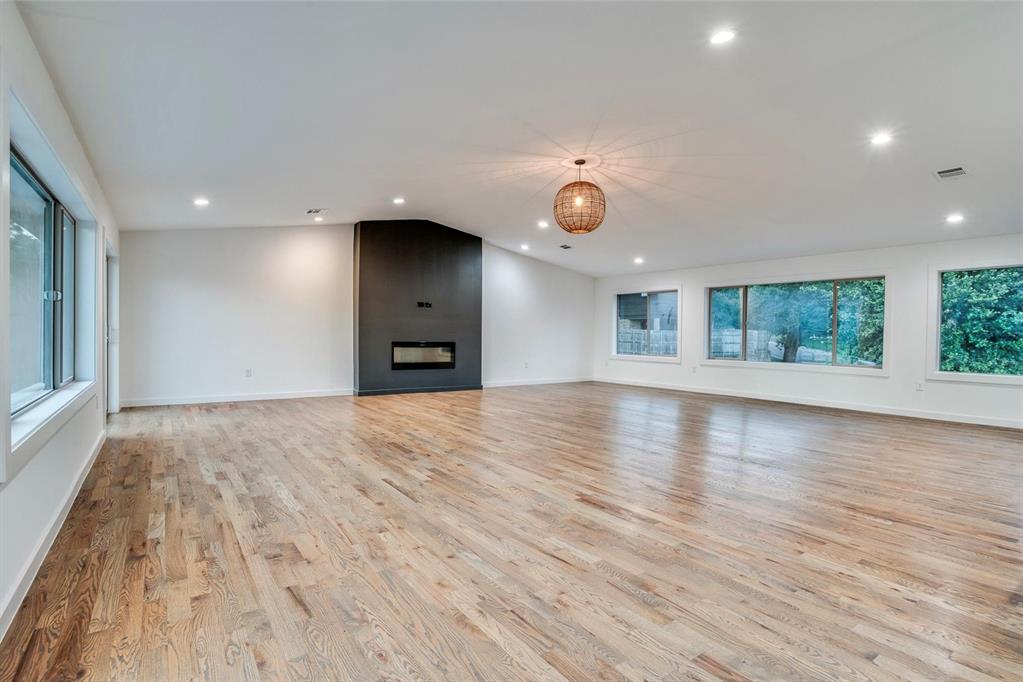 1408 South Alamo Road Rockwall, TX 75087 - Photo 22 of 40 an empty room with wooden floor and windows