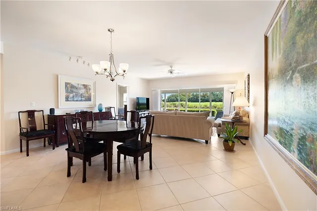 a dining room filled chandelier and fireplace