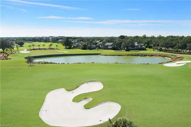 an aerial view of a residential houses with outdoor space and trees