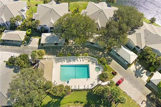 an aerial view of a house with a yard and lake view