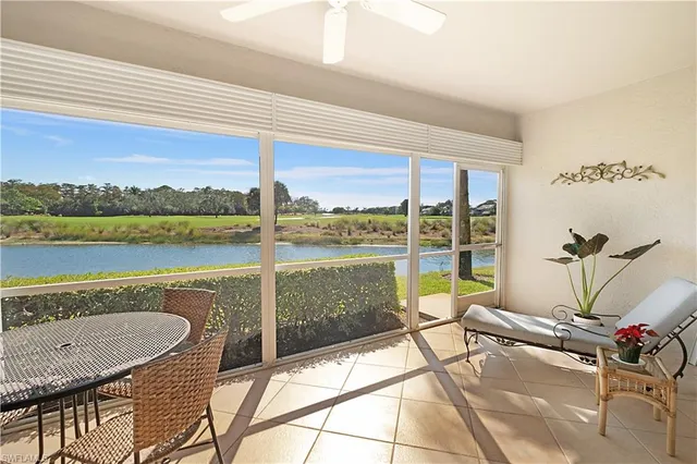 a view of a balcony with furniture and a yard