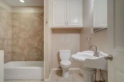 a bathroom with a sink a toilet and bathtub