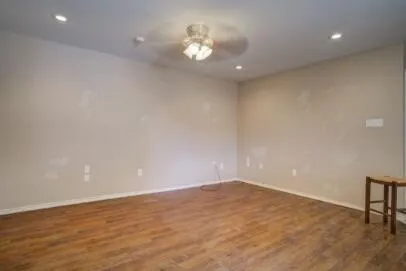 an empty room with a empty space and a ceiling fan