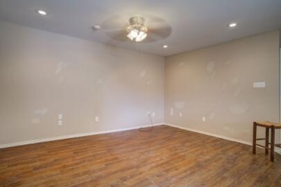 2601 33rd Street, Unit REAR Lubbock, TX 79410 - Photo 3 of 16 an empty room with a empty space and a ceiling fan
