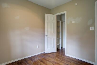 2601 33rd Street, Unit REAR Lubbock, TX 79410 - Photo 9 of 16 an empty room with wooden floor and entrance