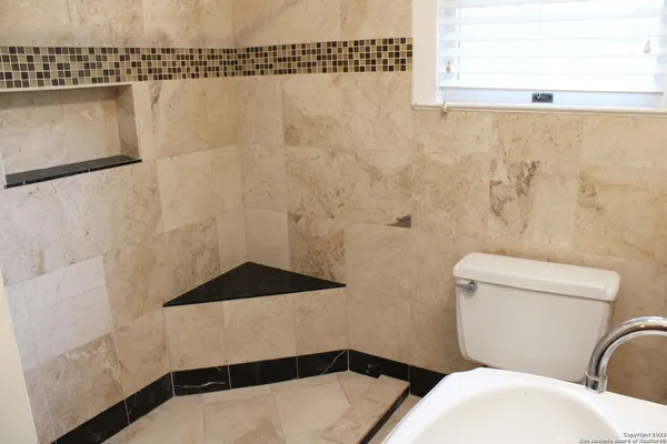 a bathroom with a toilet and a shower curtain