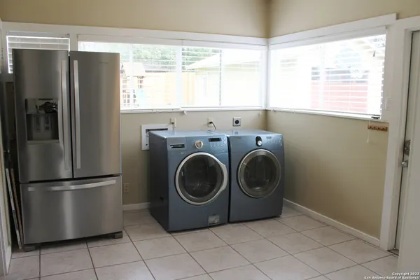 a utility room with window dryer and washer