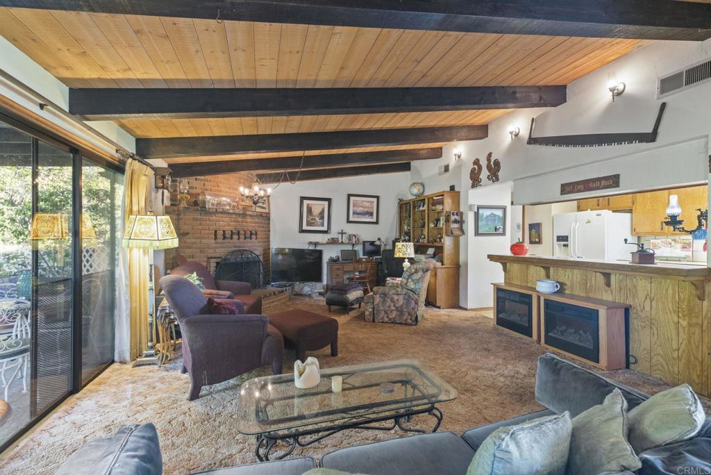 3414 Royal Road Vista, CA 92084 - Photo 13 of 48 a living room with furniture a rug and a fireplace
