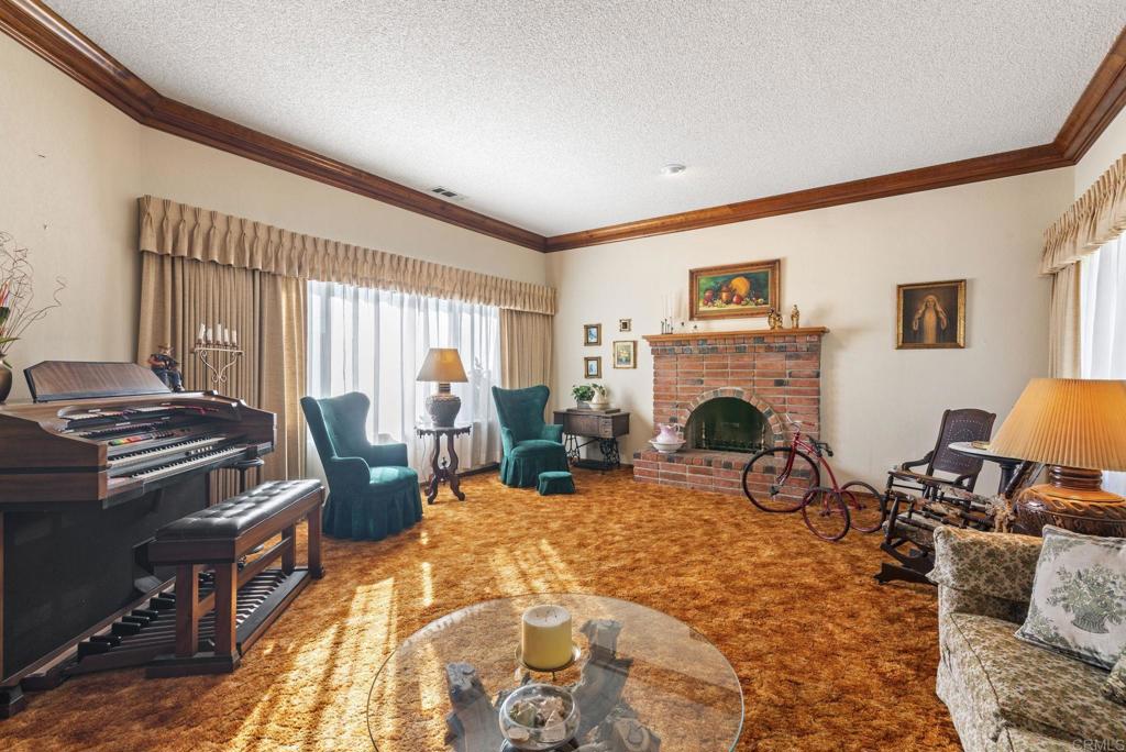 3414 Royal Road Vista, CA 92084 - Photo 20 of 48 a living room with furniture a fireplace and a flat screen tv