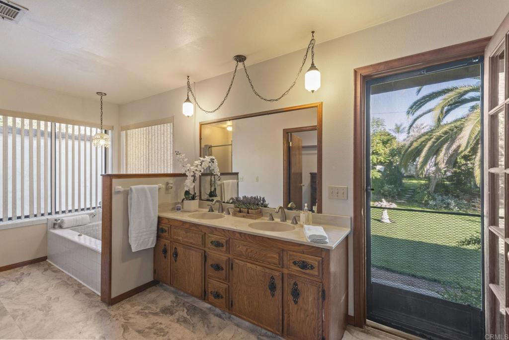 3414 Royal Road Vista, CA 92084 - Photo 29 of 48 a bathroom with a double vanity sink and mirror