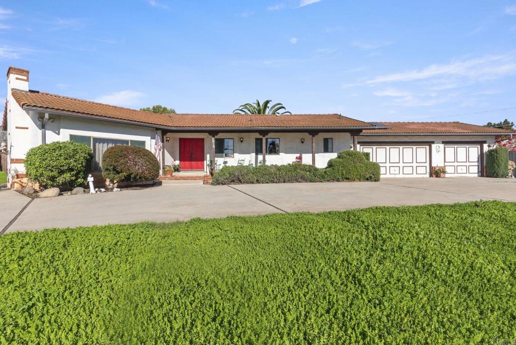 3414 Royal Road Vista, CA 92084 - Photo 4 of 48 a front view of a house with a yard and potted plants