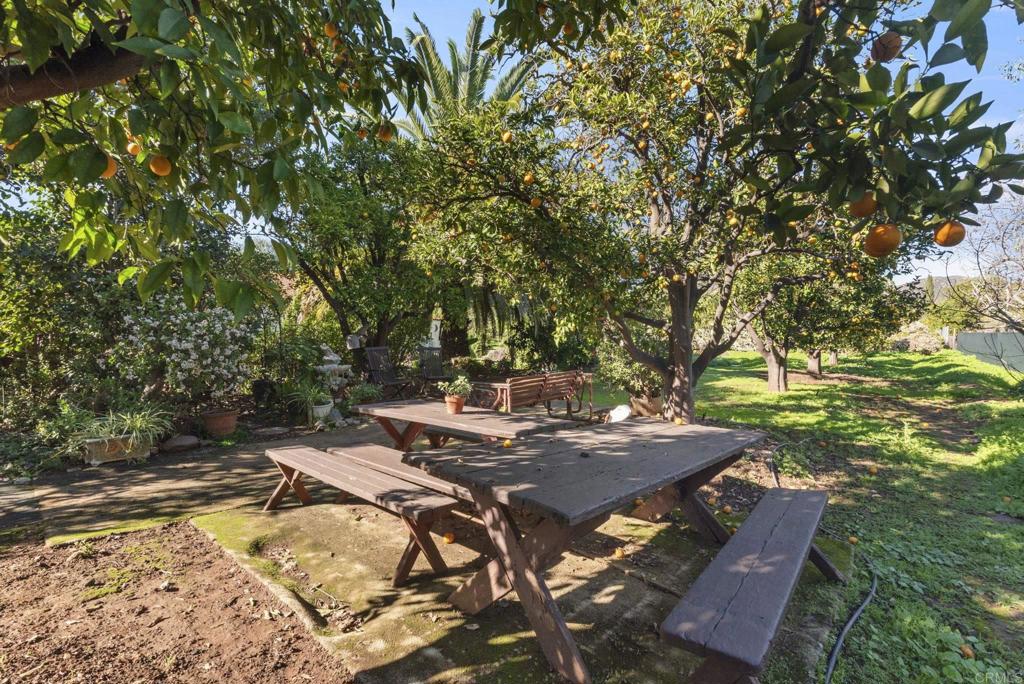 3414 Royal Road Vista, CA 92084 - Photo 42 of 48 a view of a backyard with table and chairs under an umbrella