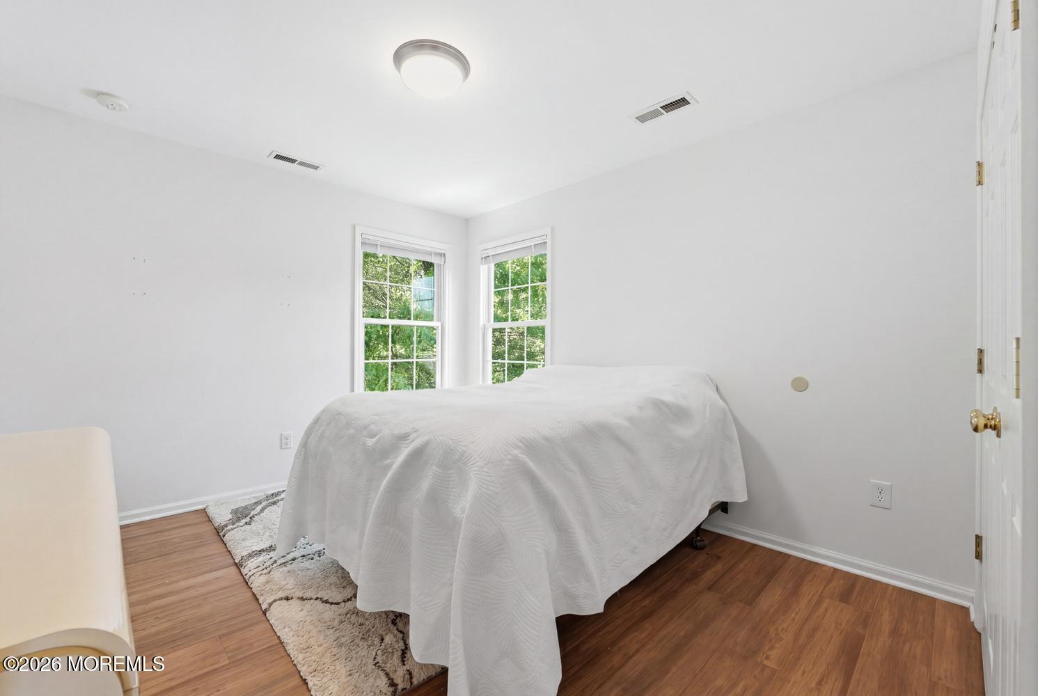 7 Cherry Tree Lane Cream Ridge, NJ 08514 - Photo 30 of 47 a bed sitting in a bedroom next to a window