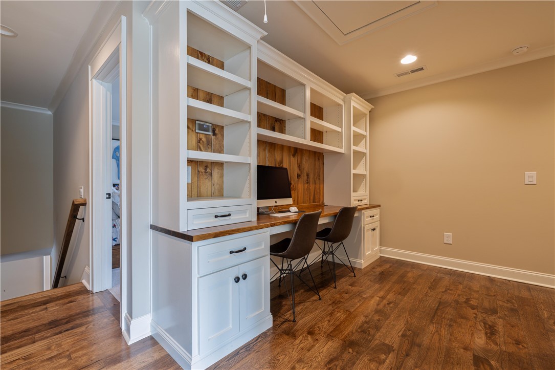 301 Stonebridge Drive Clemson, SC 29631 - Photo 33 of 47 This dedicated workspace features integrated shelving and rich wood flooring.