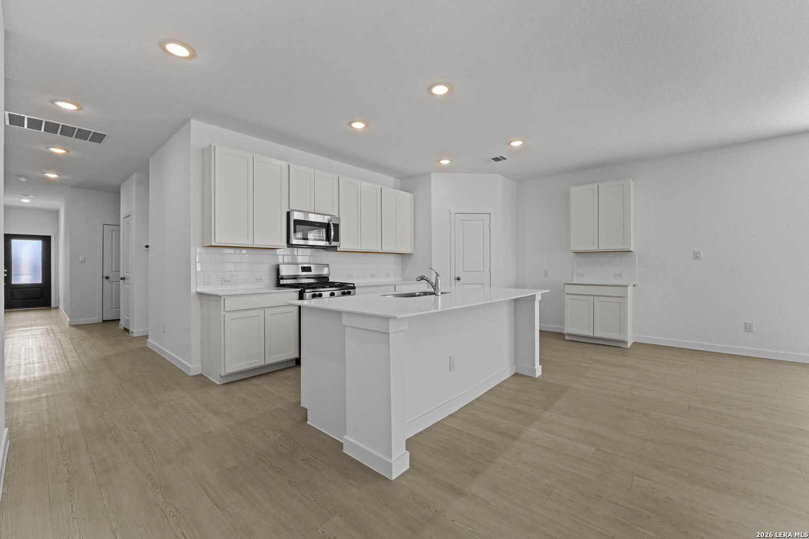 4987 Mission Tejas Road Marion, TX 78124 - Photo 15 of 25 a kitchen with white cabinets and stainless steel appliances