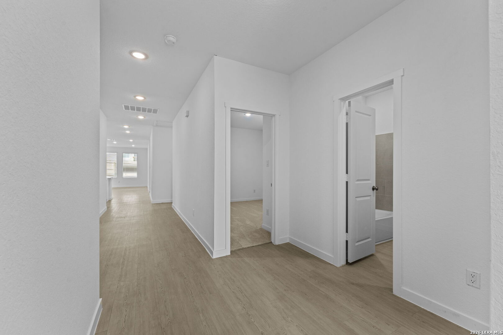 4987 Mission Tejas Road Marion, TX 78124 - Photo 2 of 25 a view of a hallway with wooden floor and a bathroom