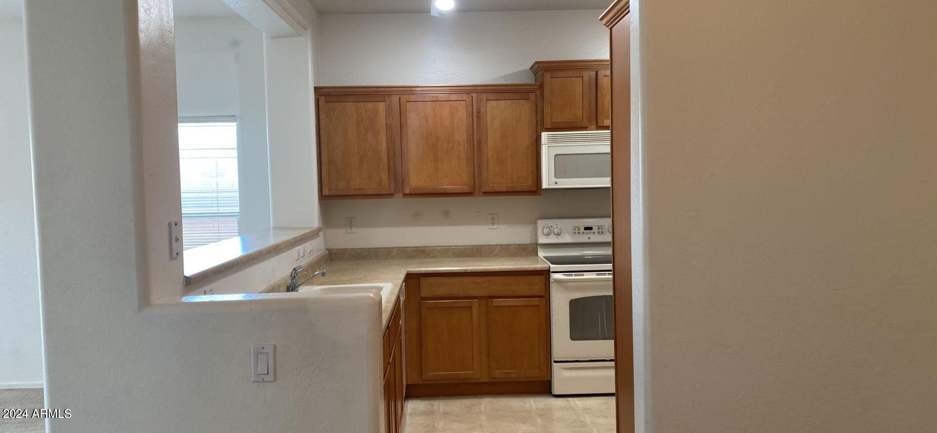 5257 West Shumway Farm Road Laveen, AZ 85339 - Photo 7 of 13 a kitchen with a refrigerator and a stove top oven