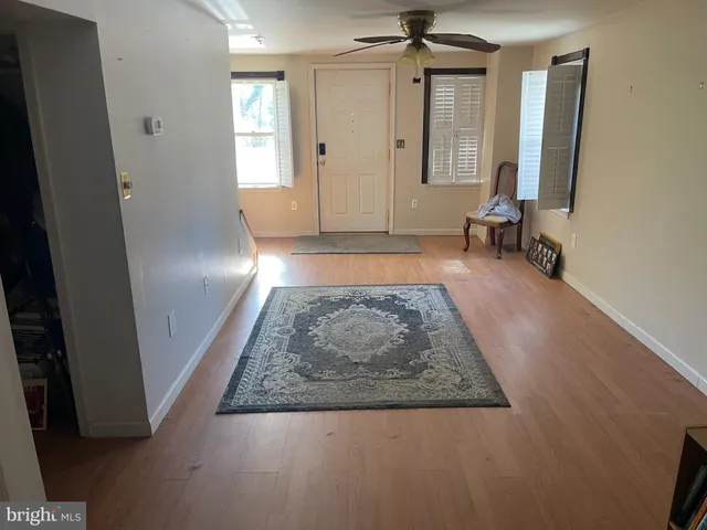 a view of livingroom with hardwood floor and a ceiling fan