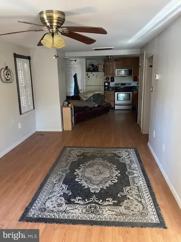 a living room with stainless steel appliances furniture