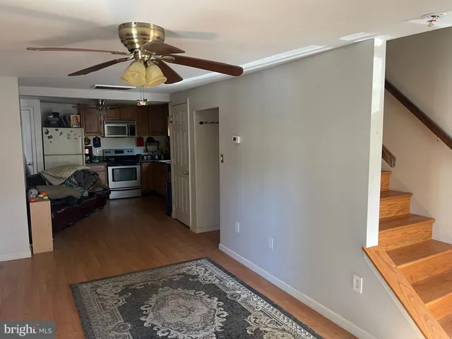a view of a kitchen with a sink stainless steel appliances and cabinets