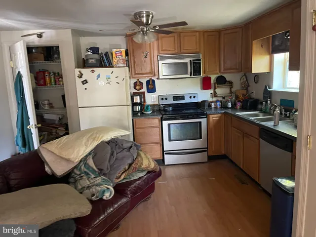 a kitchen with a sink appliances and cabinets