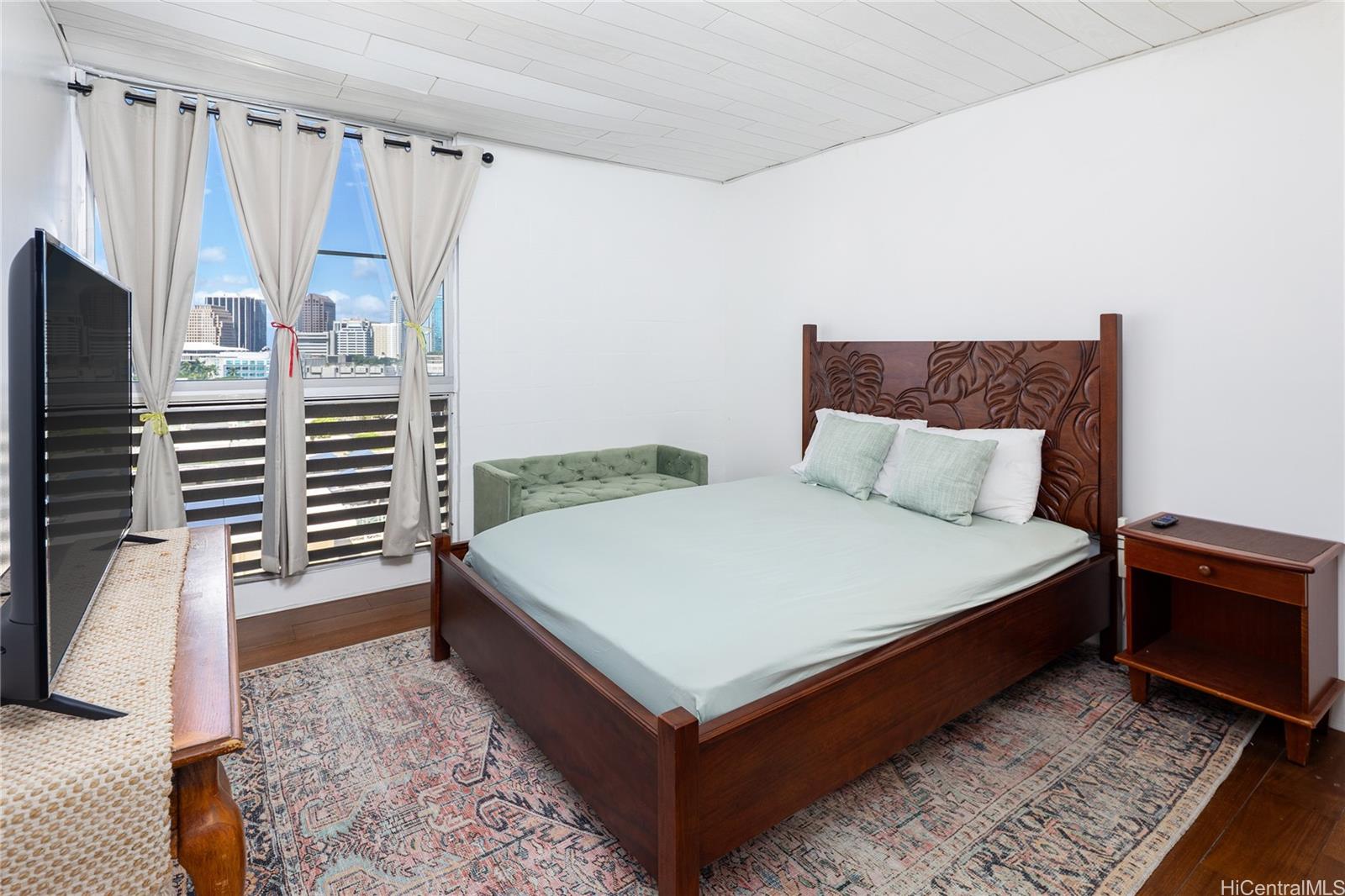 785 Kinau Street, Unit 804 Honolulu, HI 96813 - Photo 13 of 16 a bedroom with a bed and a walk in closet