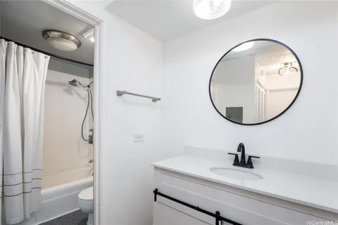 a bathroom with a sink a toilet and a mirror