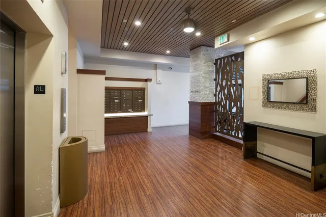 a view of hallway with furniture and wooden floor
