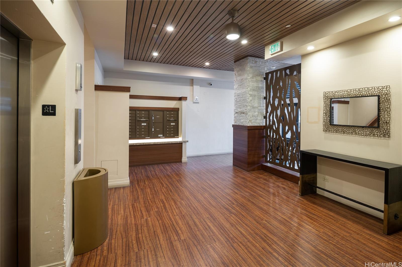 785 Kinau Street, Unit 804 Honolulu, HI 96813 - Photo 4 of 16 a view of hallway with furniture and wooden floor