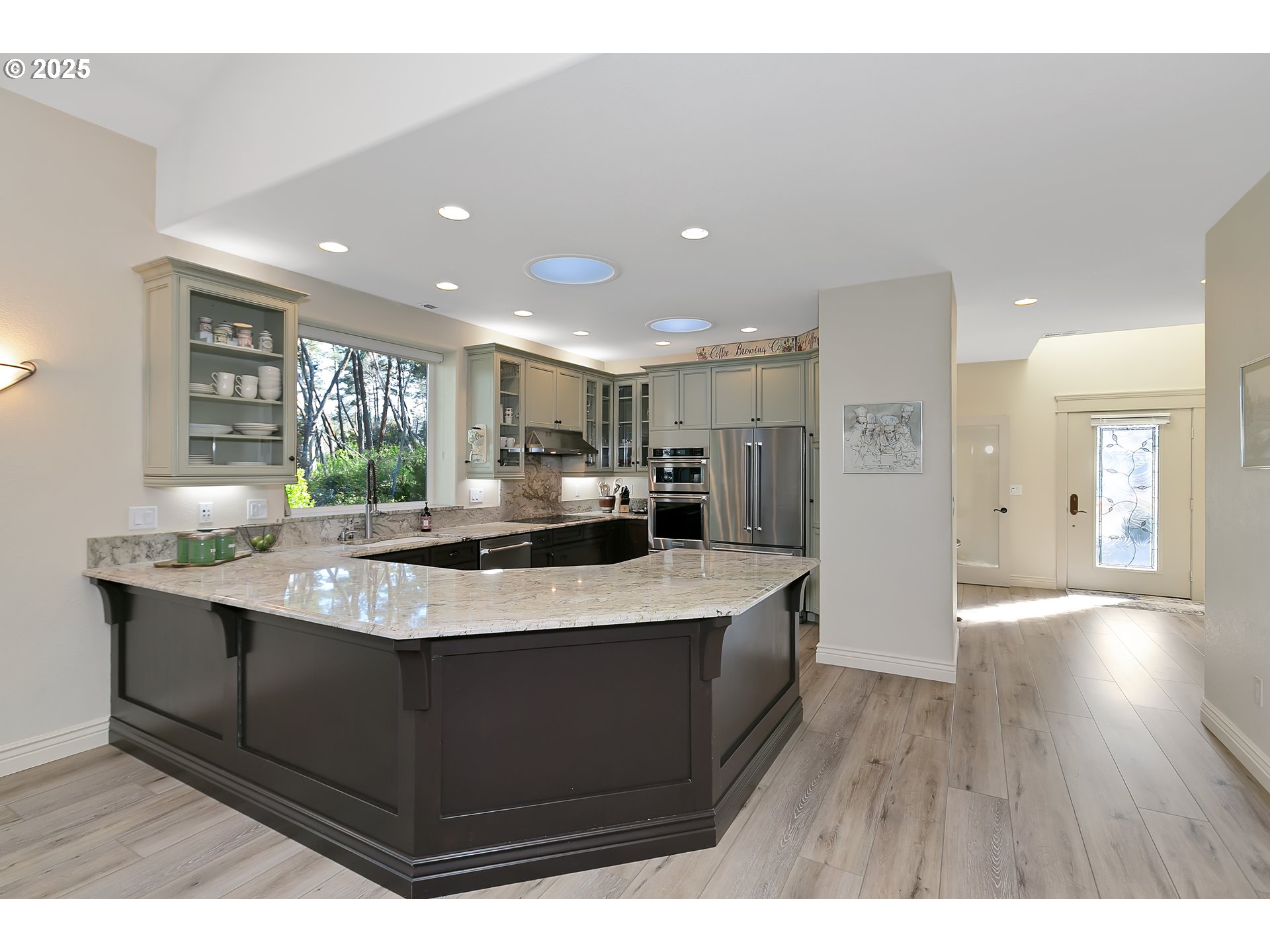 160 Southwest 59th Street South Beach, OR 97366 - Photo 12 of 45 a large kitchen with kitchen island a sink stainless steel appliances and cabinets