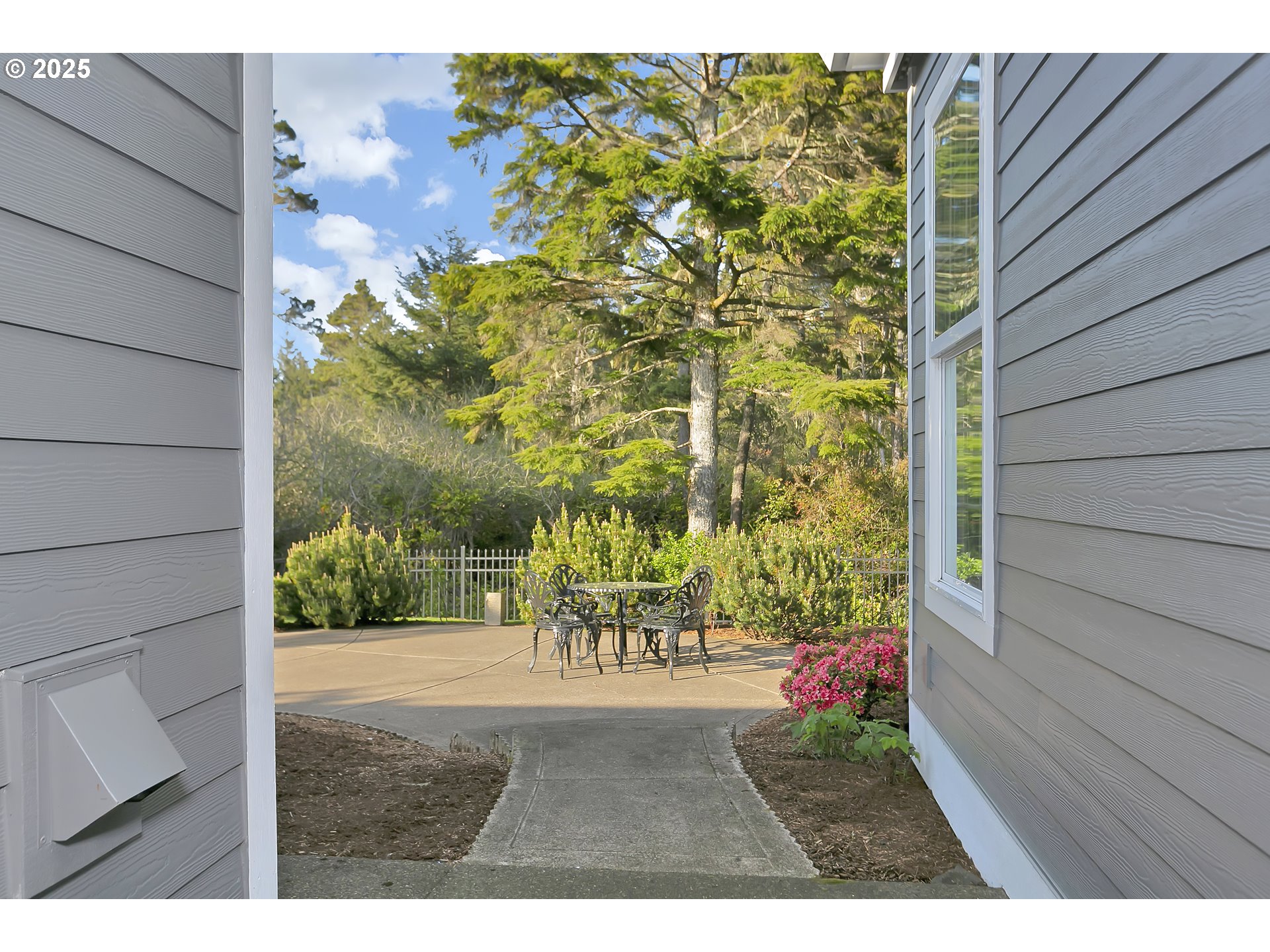160 Southwest 59th Street South Beach, OR 97366 - Photo 27 of 45 a balcony with table and chairs and potted plants