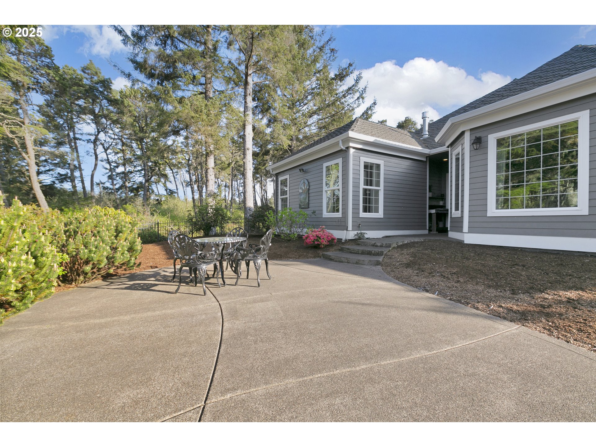 160 Southwest 59th Street South Beach, OR 97366 - Photo 28 of 45 a patio with a table and chairs and potted plants
